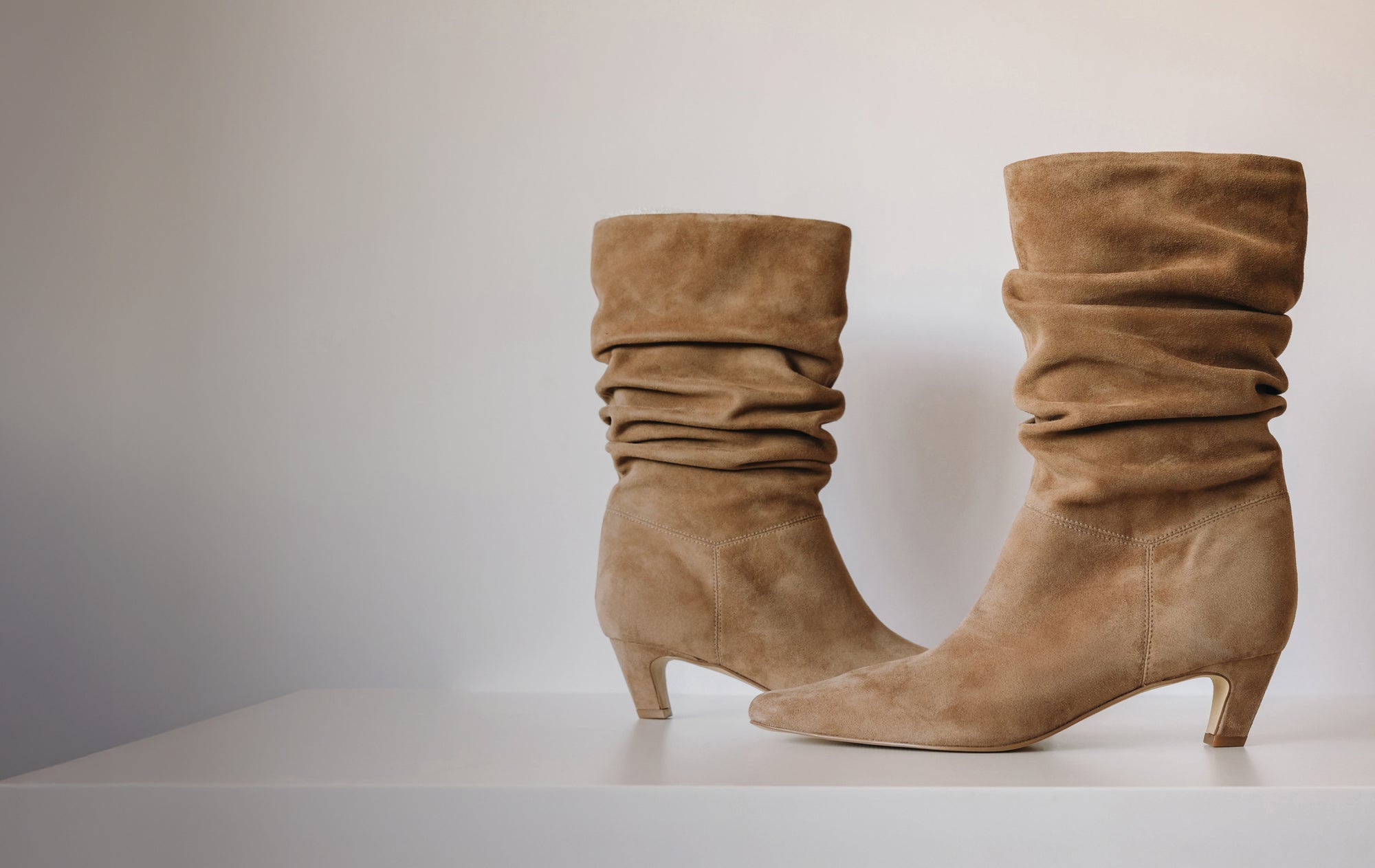 Editorial banner featuring slouch boots