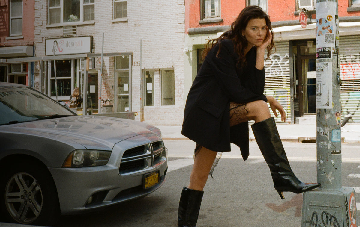 Editorial banner featuring model wearing Erynn Leather Knee High Boots